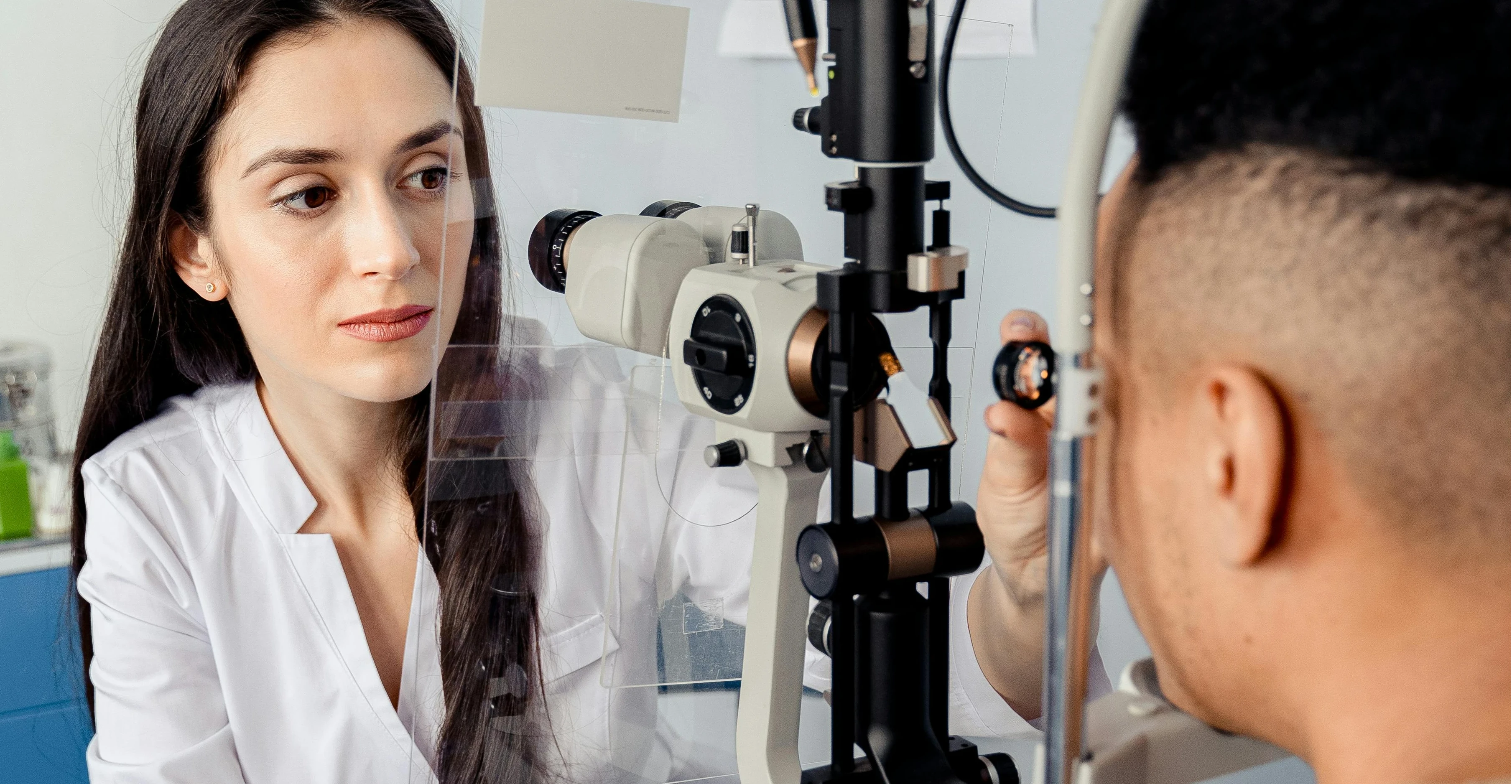 Modern eye clinic with advanced diagnostic equipment and ophthalmologist examining patient